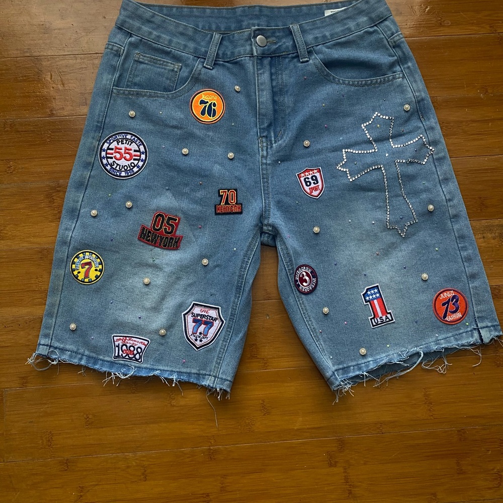 custom made shorts with patches, rhinestones, and pearls.